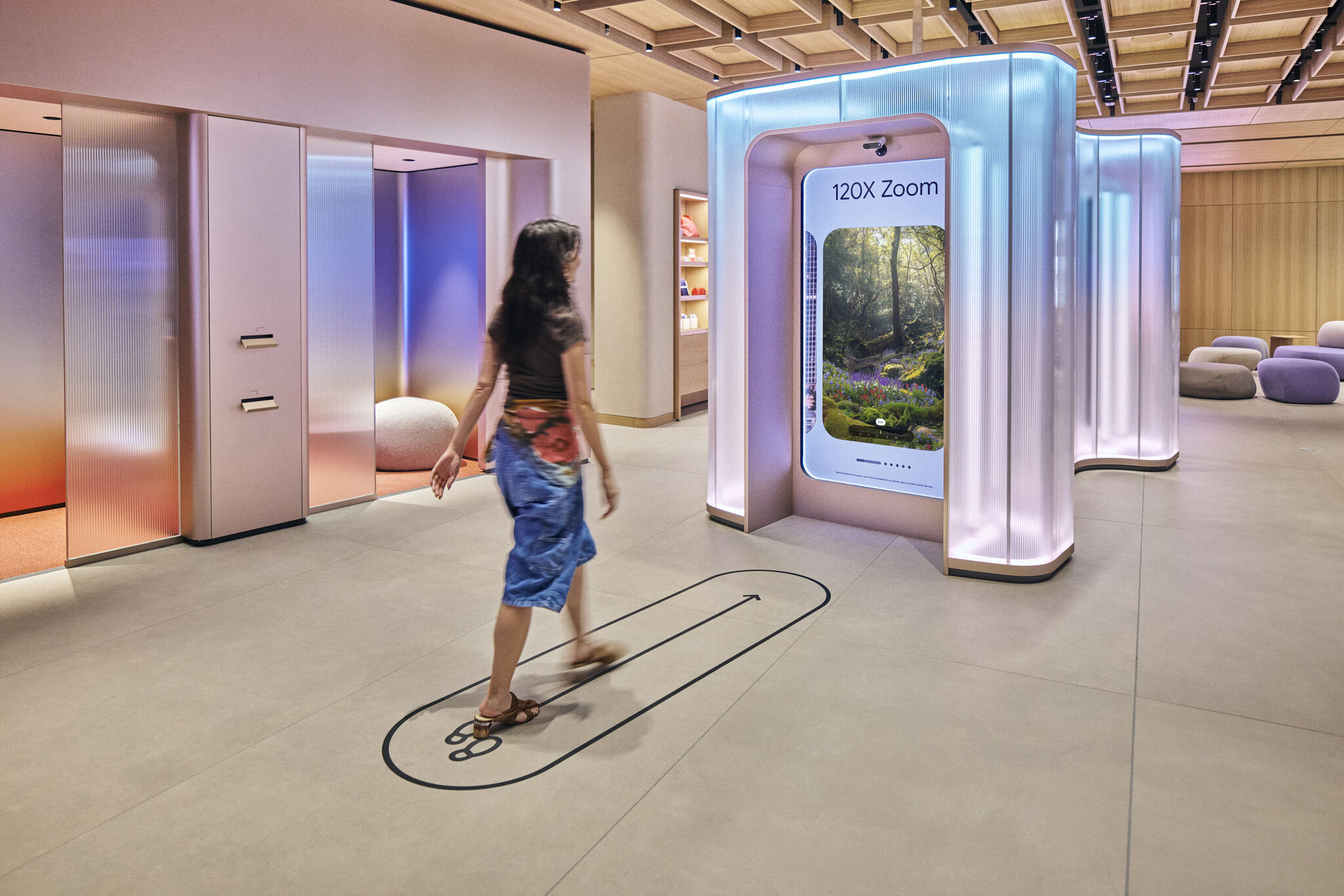 Google store visitor walking past an interactive 120X Zoom photo demo display